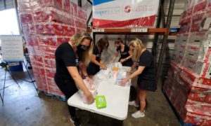 The Junior League of Tampa Members packing diapers at the Diaper Bank