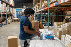 Member of The Junior League of Tampa packing diapers