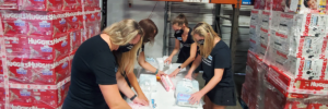 The Junior League of Tampa Diaper Bank volunteers packing diapers.