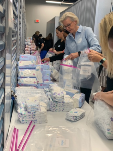 Tampa Mayor Jane Castor packing diapers with The Junior League of Tampa Diaper Bank